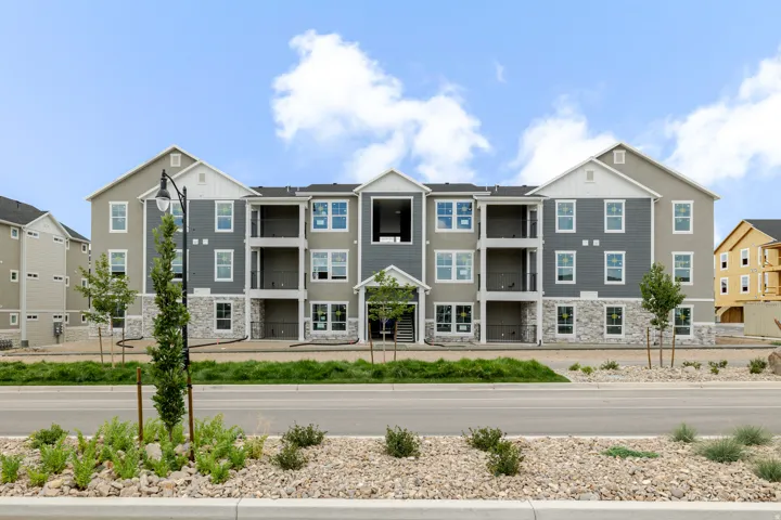 Contemporary multi-story building featuring gray siding and white trim