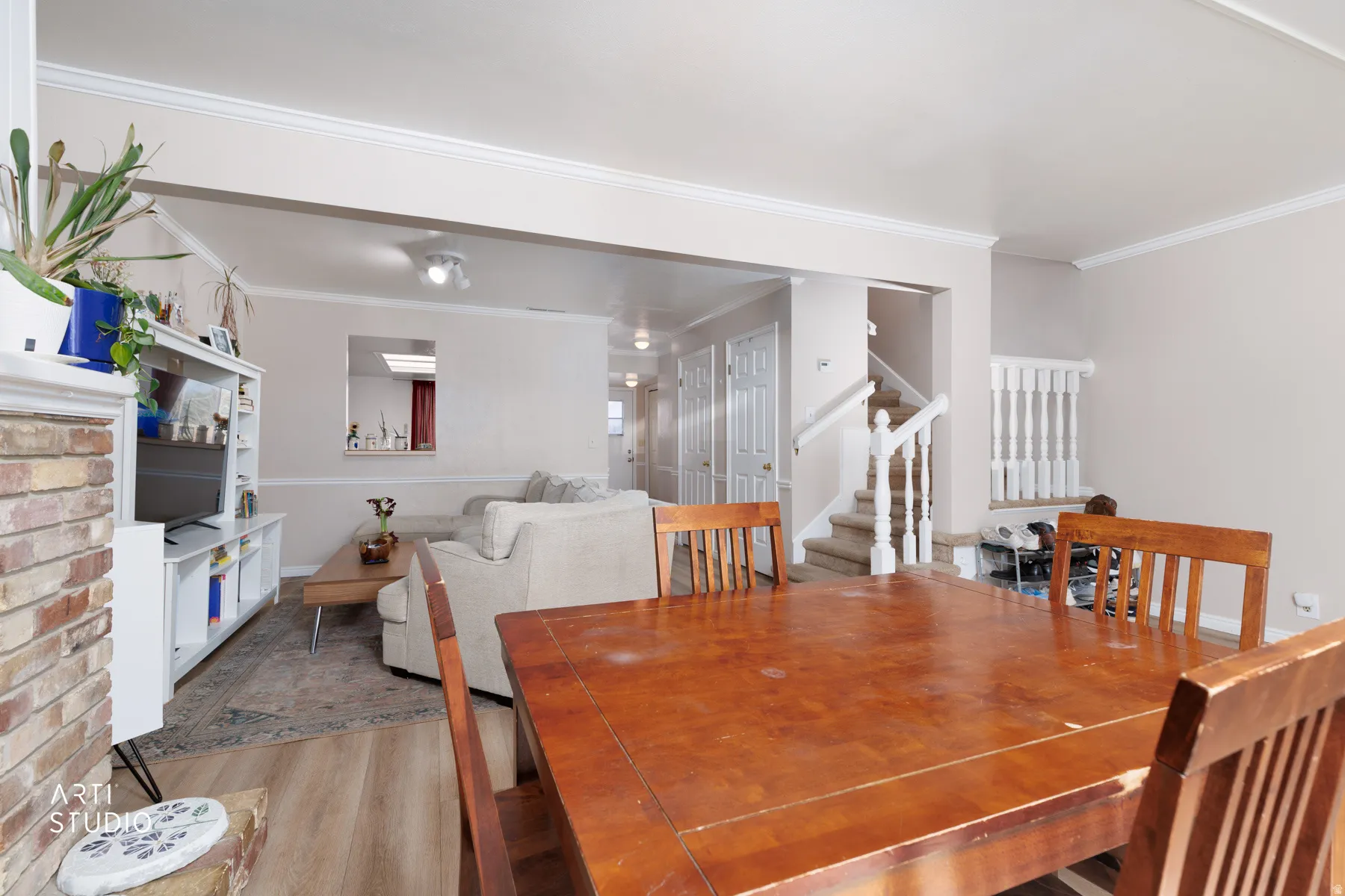 Dining area with light wood-style floors and ornamental molding