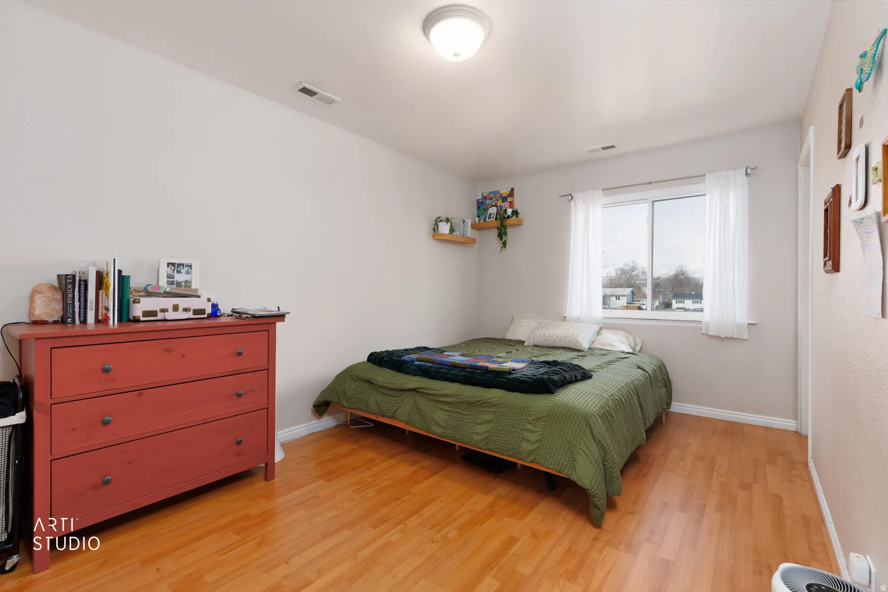 Bedroom with light wood finished floors and baseboards