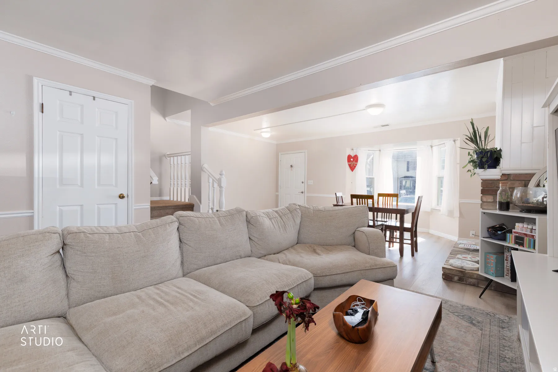 Living area featuring crown molding and wood finished floors