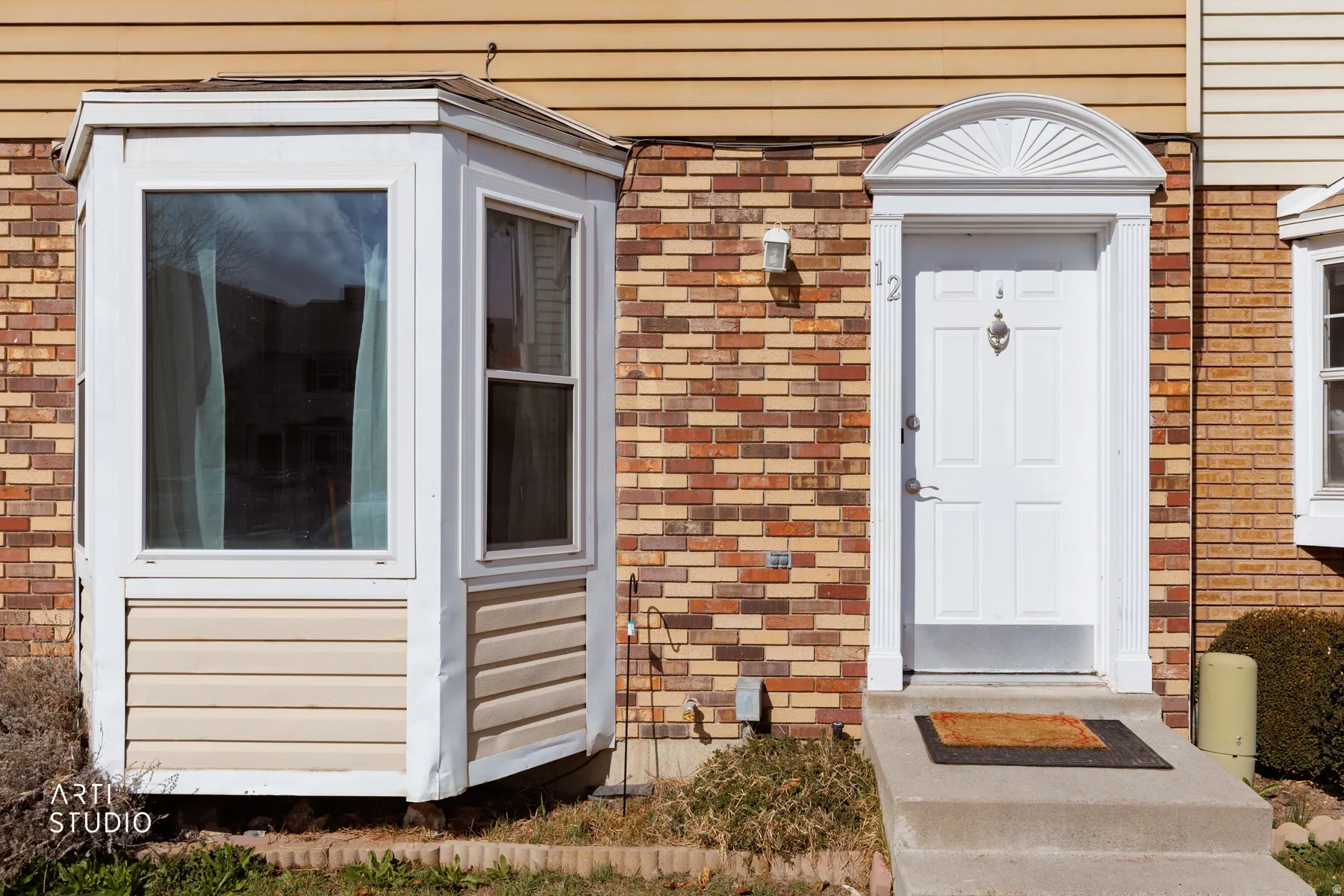 Entrance to property with brick siding