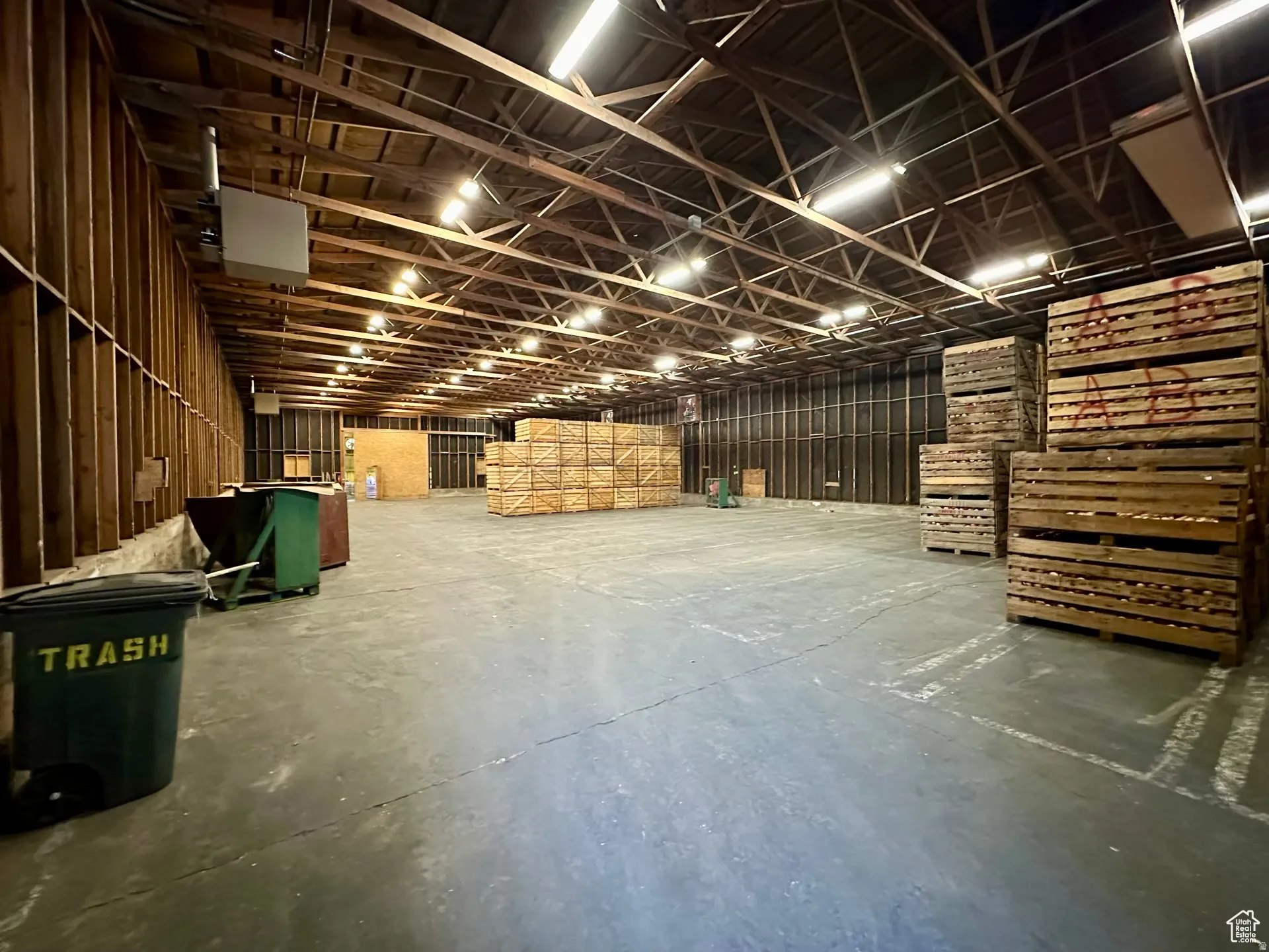 Miscellaneous room with unfinished concrete flooring and a heating unit