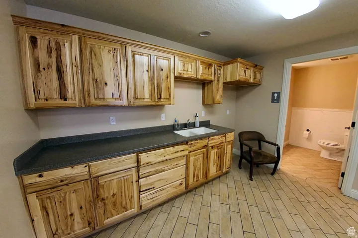 Kitchen featuring wood finish floors and a sink