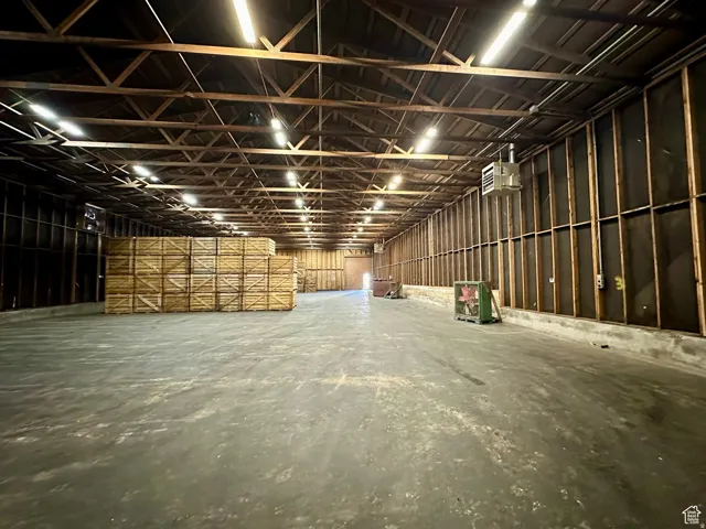 Misc room with a heating unit and unfinished concrete flooring
