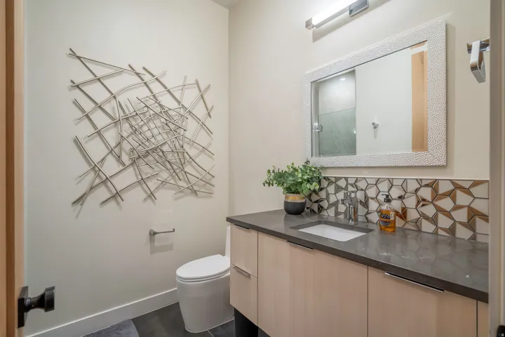 Full bath featuring vanity, tasteful backsplash, and a shower