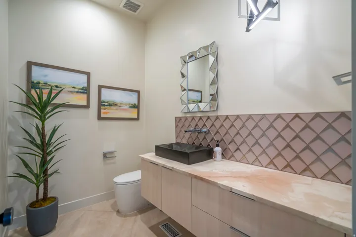 Bathroom with vanity and tasteful backsplash