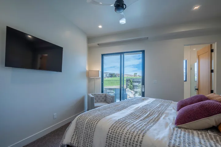 Carpeted bedroom with a ceiling fan, access to outside, and recessed lighting