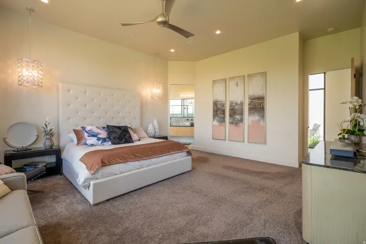 Bedroom featuring dark colored carpet, ceiling fan, recessed lighting, a high ceiling, and ensuite bath