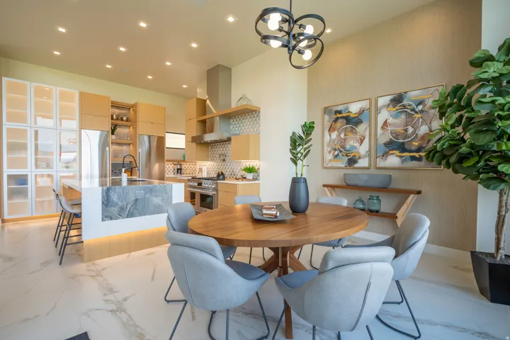 Dining room with hanging lights and light marble finish flooring
