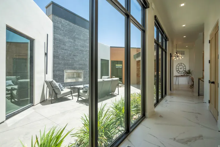 Entryway featuring a chandelier and a glass covered fireplace