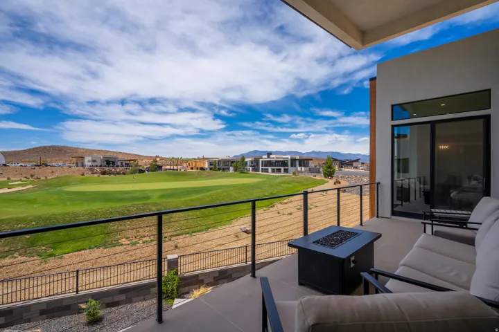 Balcony with a fire pit, a mountain view, and golf course view
