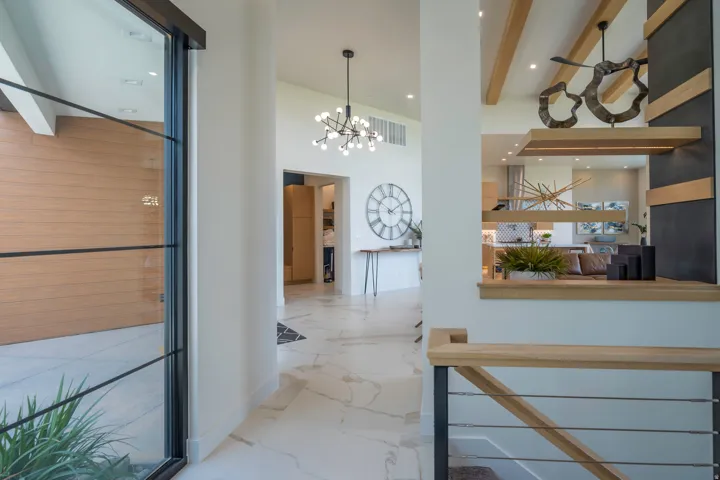 Hall with a chandelier and baseboards