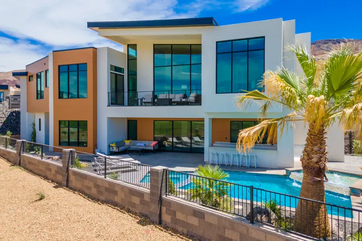 Back of property featuring a patio area, outdoor lounge area, and stucco siding