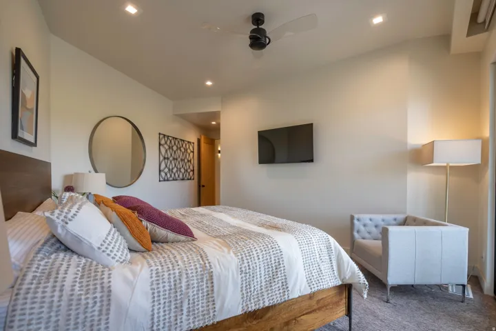 Carpeted bedroom featuring a ceiling fan and recessed lighting