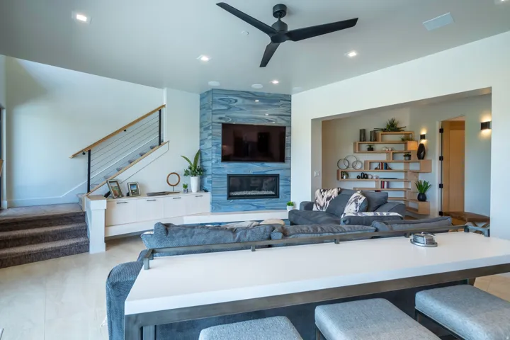 Living area featuring ceiling fan, a high end fireplace, and recessed lighting