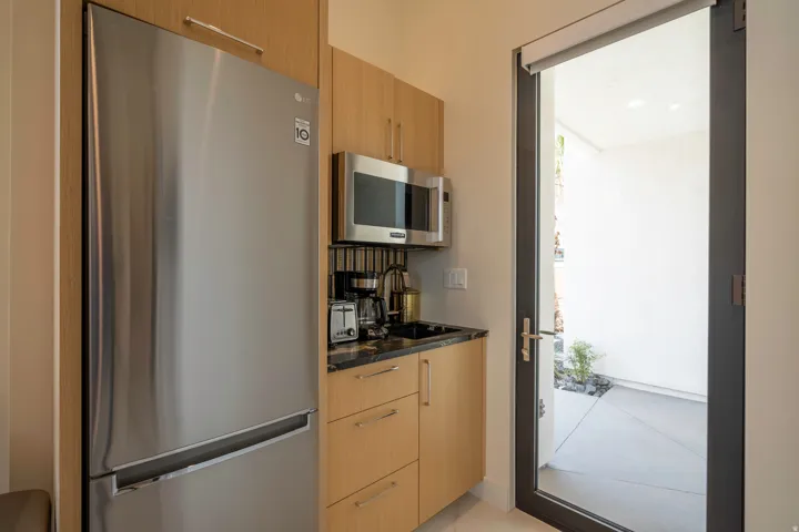 Kitchen with stainless steel appliances, modern cabinets, and light wood finish cabinets