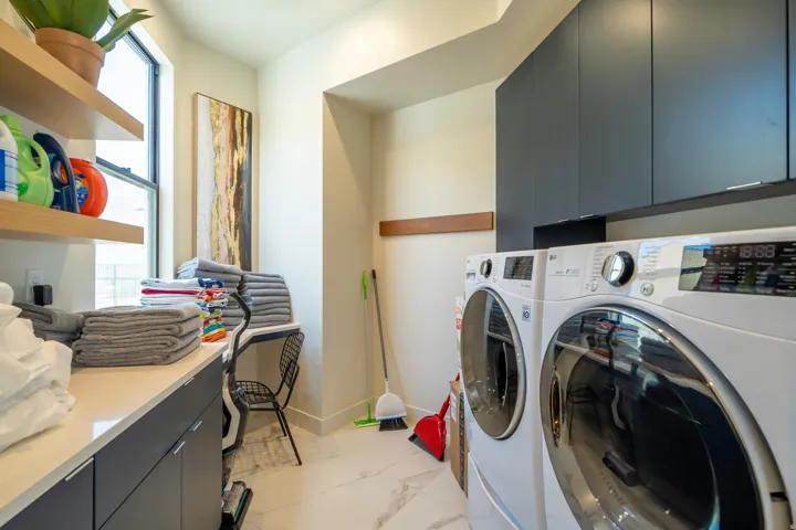 Laundry room featuring cabinet space and separate washer and dryer
