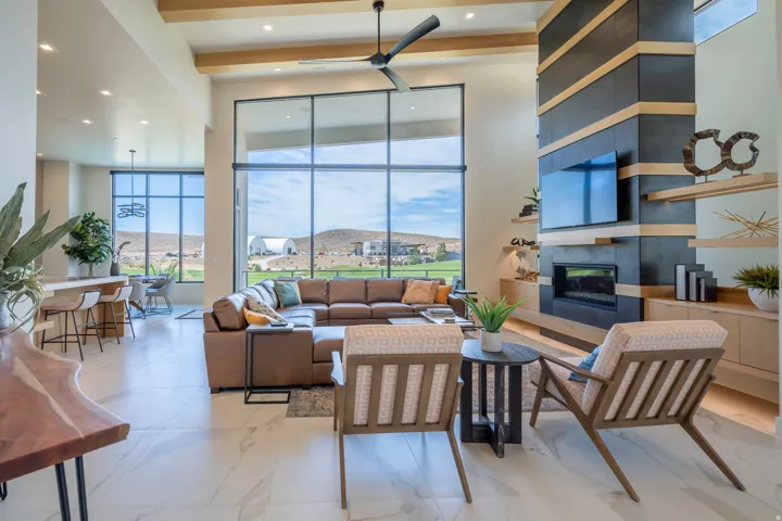 Living area featuring a tiled fireplace, ceiling fan, and recessed lighting