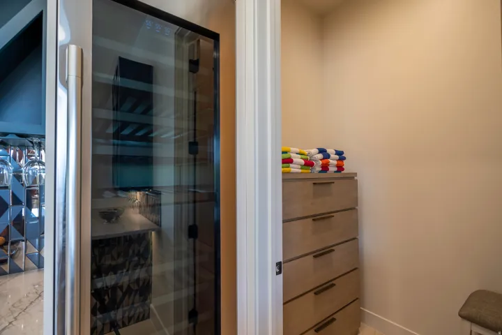 Bathroom with a shower stall, wine cooler, and vanity