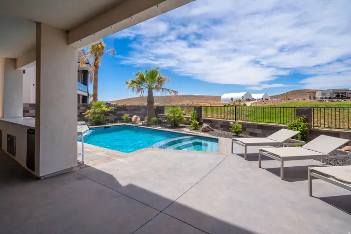 Integrated pool / spa featuring a patio area and a fenced backyard