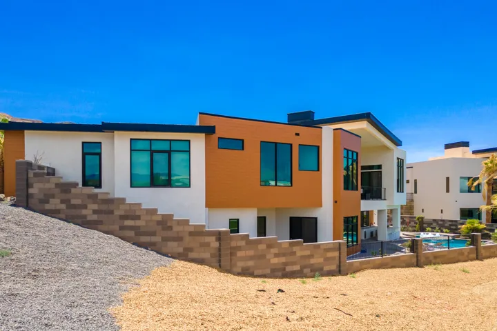 Back of house featuring stucco siding, an outdoor pool, and a patio area