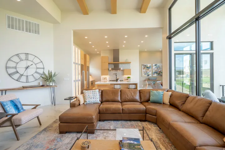 Living room featuring recessed lighting, plenty of natural light, and light marble finish flooring