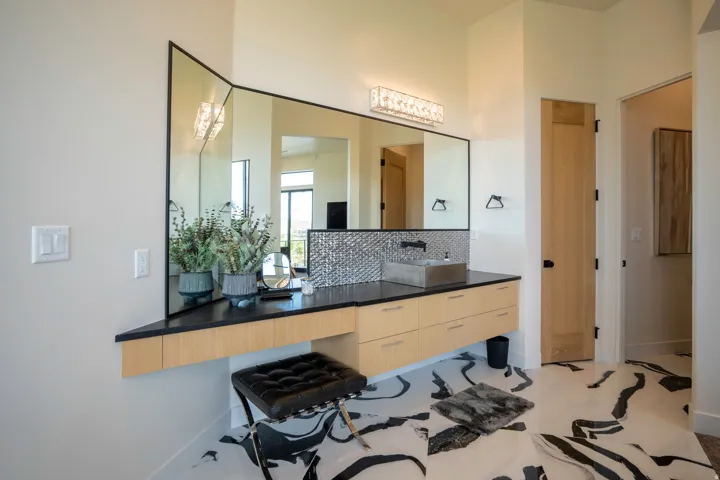 Bathroom with vanity and decorative backsplash