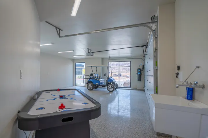 Game room with speckle patterned floor and a garage