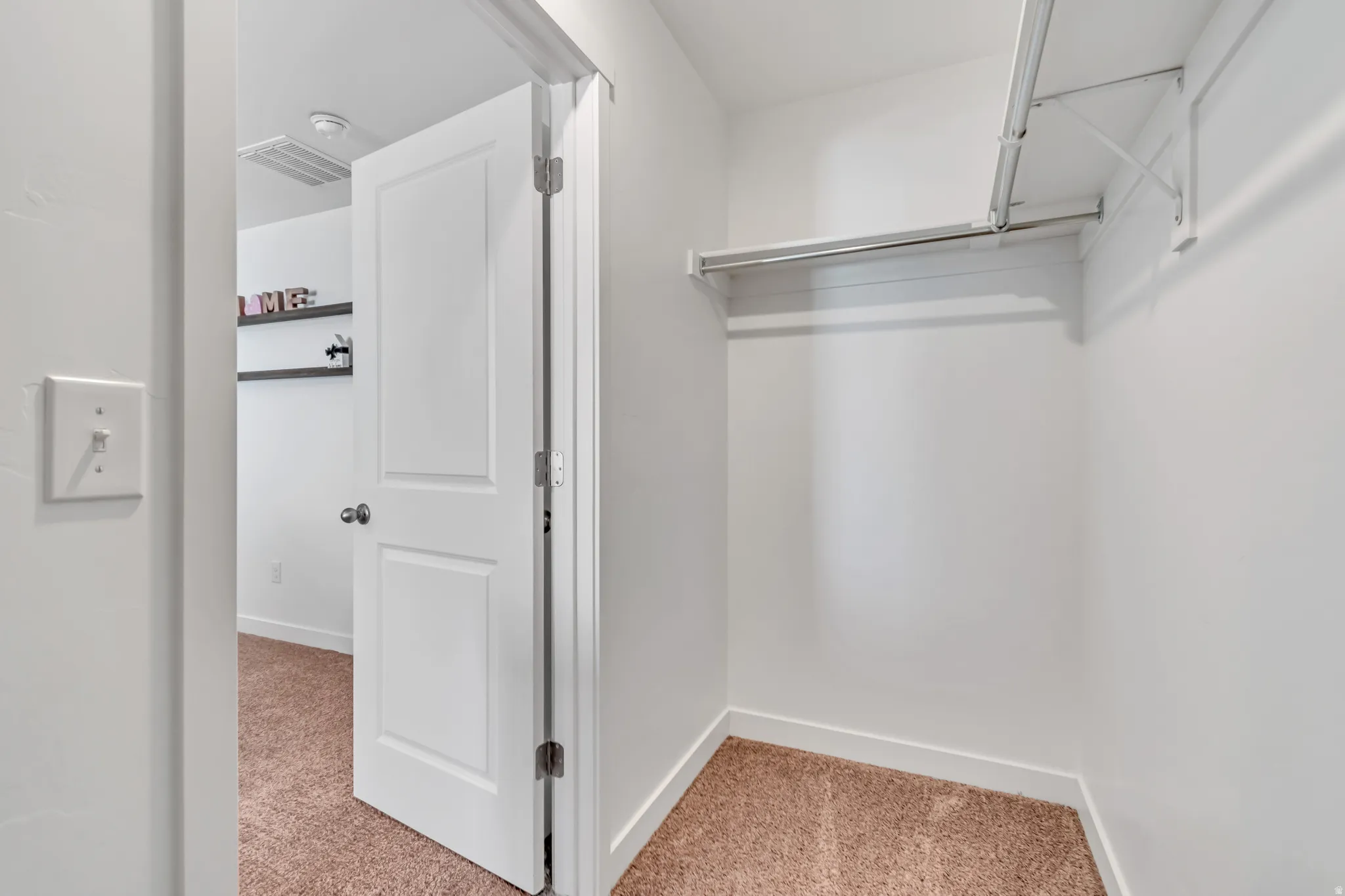 One of two walk-in closets in the primary bedroom.