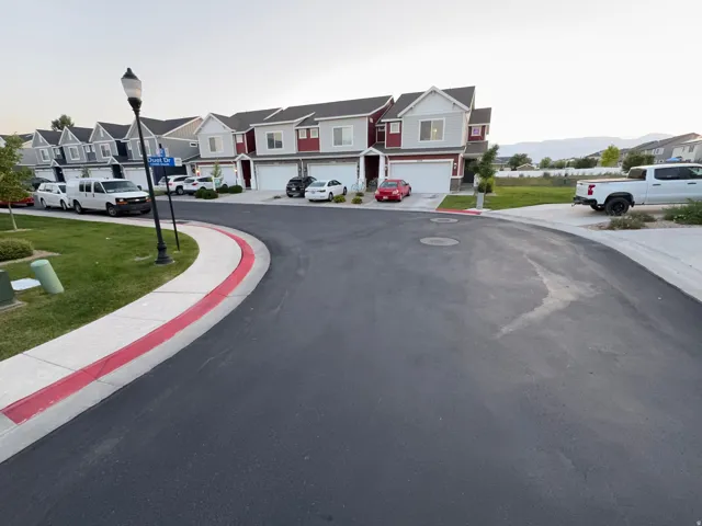 Townhome community featuring multi-story residences with attached garages and paved driveways