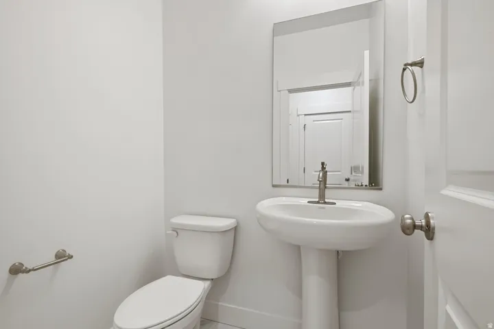 Bathroom featuring toilet and baseboards