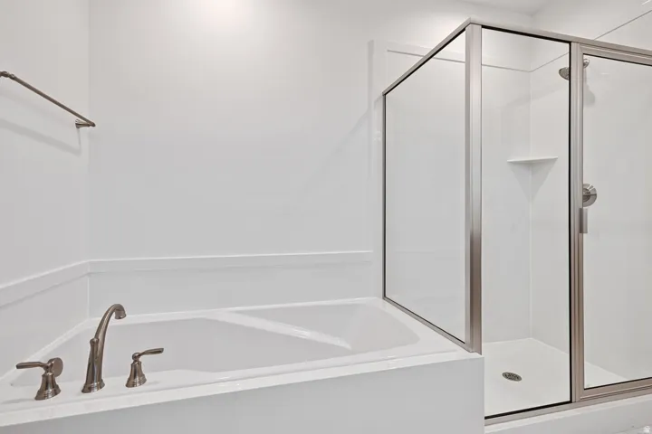 Full bath featuring a shower stall and a bath