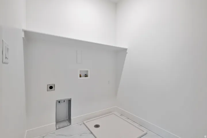 Laundry room featuring hookup for a washing machine, electric dryer hookup, and light marble finish flooring