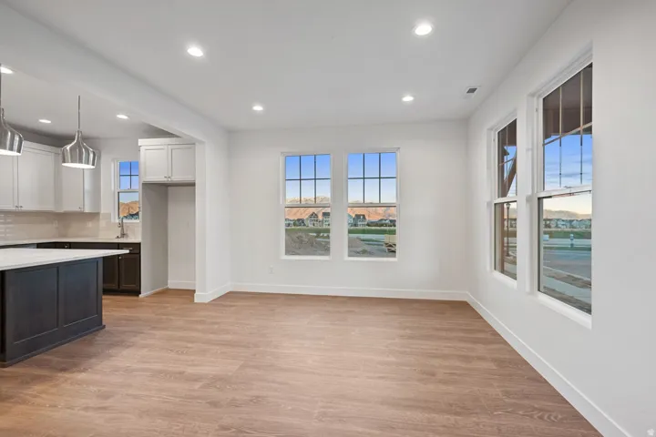 Unfurnished dining area featuring light wood finished floors and recessed lighting
