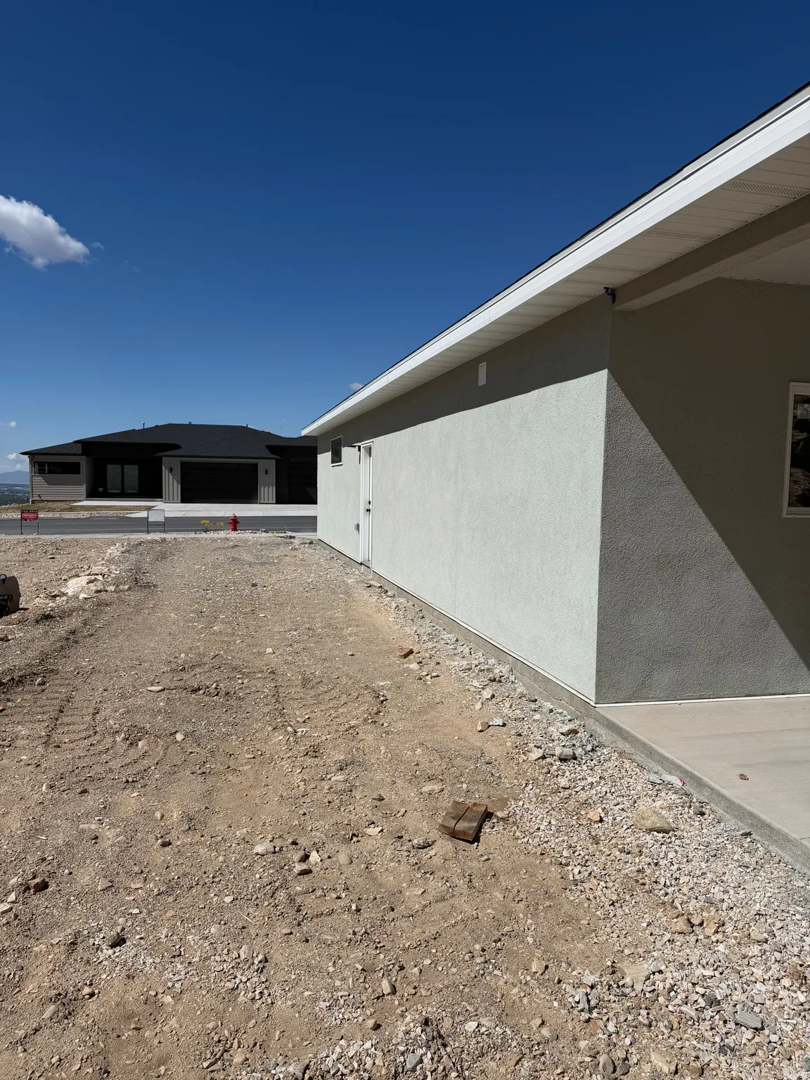 View of side of home with stucco siding