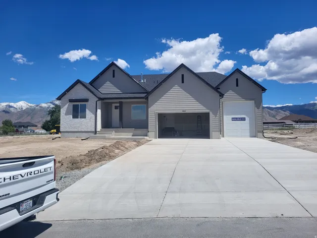 Modern single-story residence with a multi-gabled roofline and a combination of stucco and siding exterior finishes