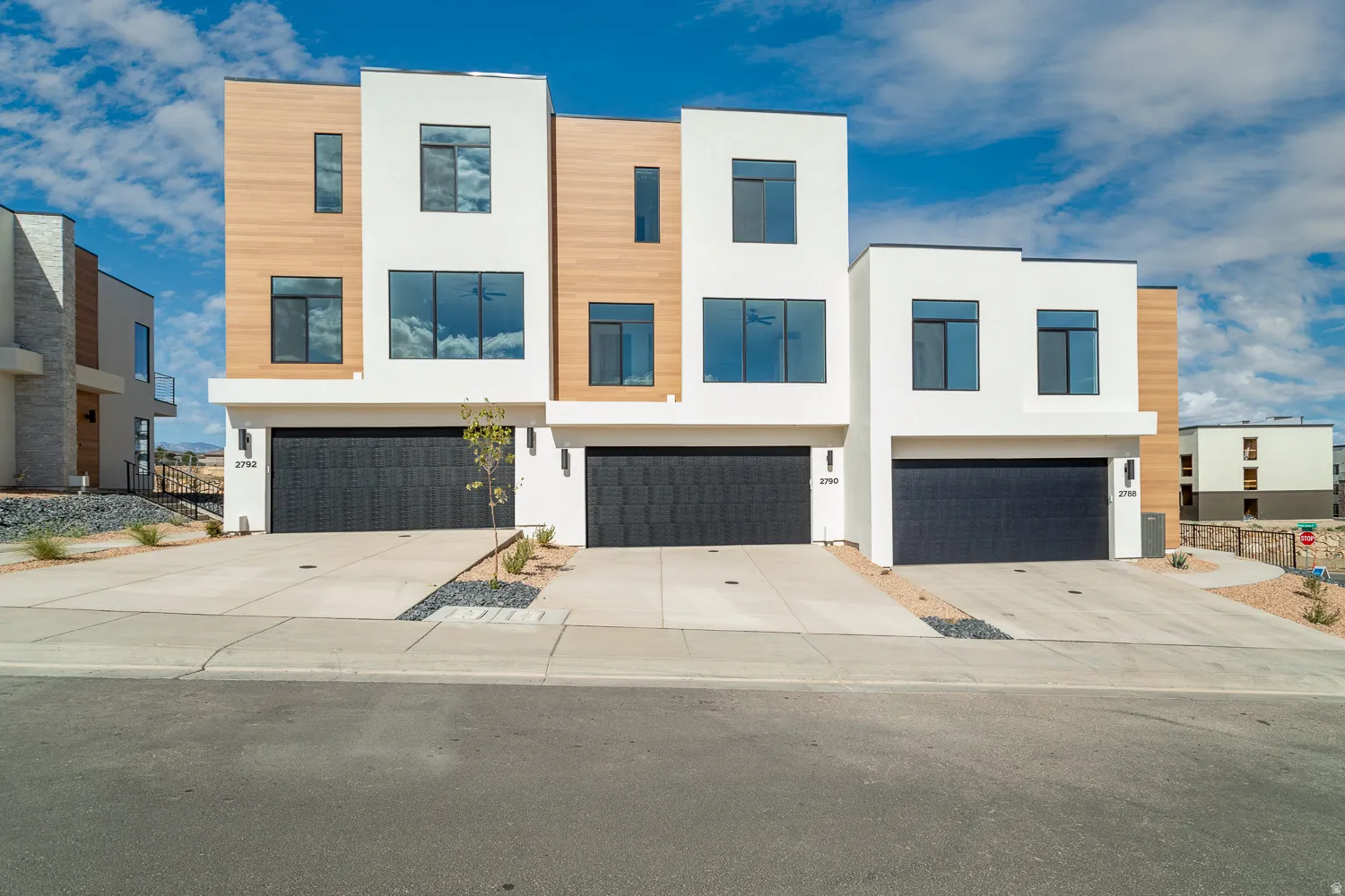 Contemporary home featuring stucco siding, concrete driveway, and an attached garage