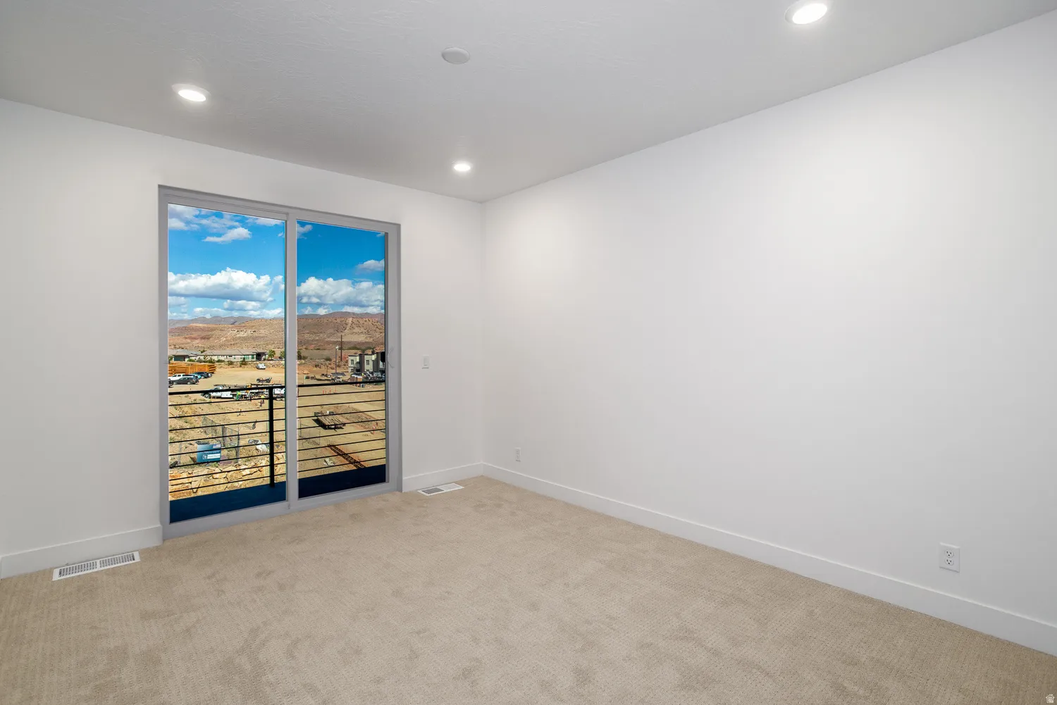 Unfurnished room featuring light carpet, recessed lighting, and a mountain view