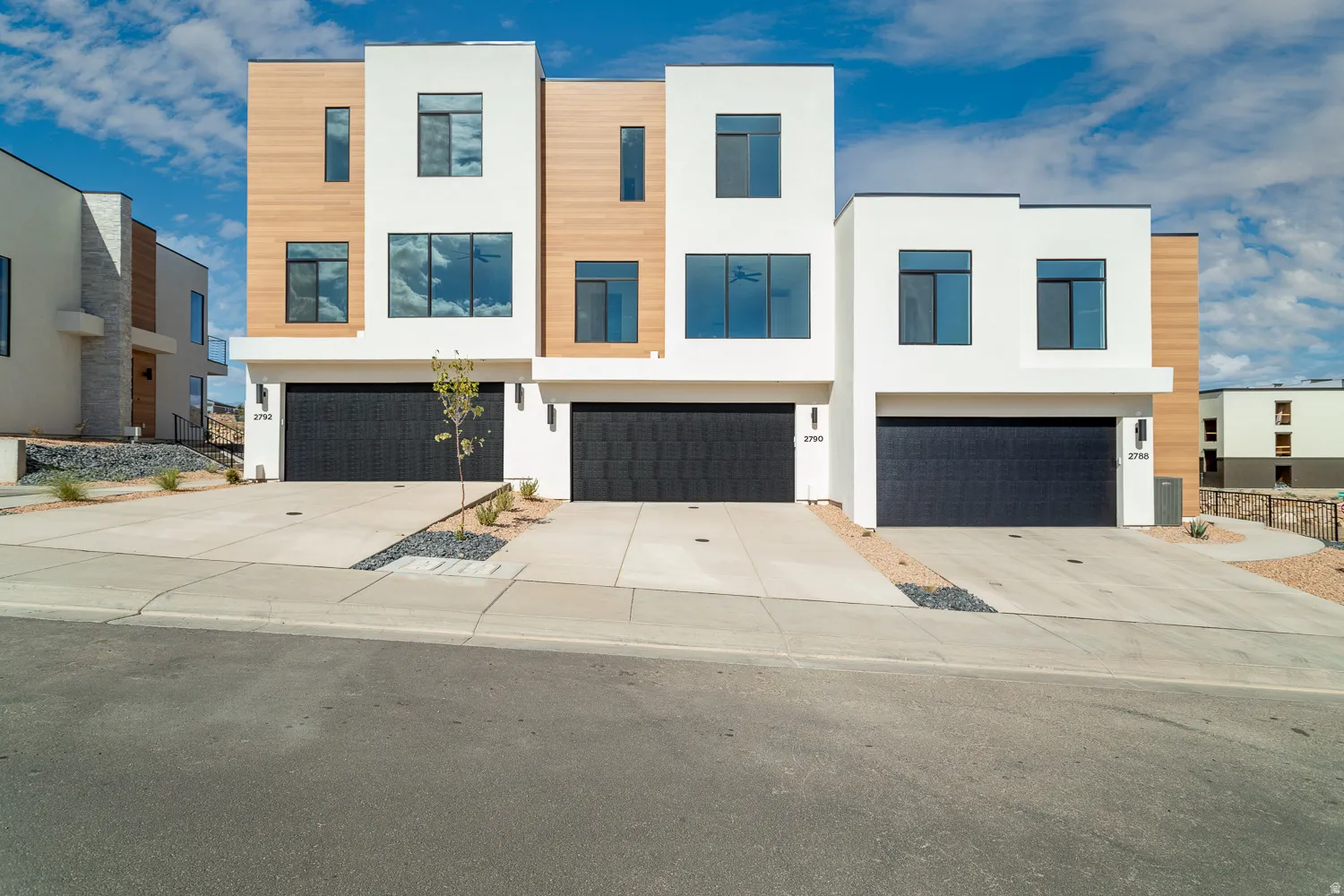 Modern home featuring stucco siding, concrete driveway, and a garage