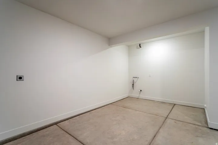 Laundry area featuring concrete flooring and hookup for an electric dryer