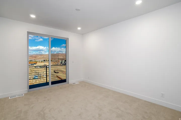 Unfurnished room featuring light carpet, recessed lighting, and a mountain view