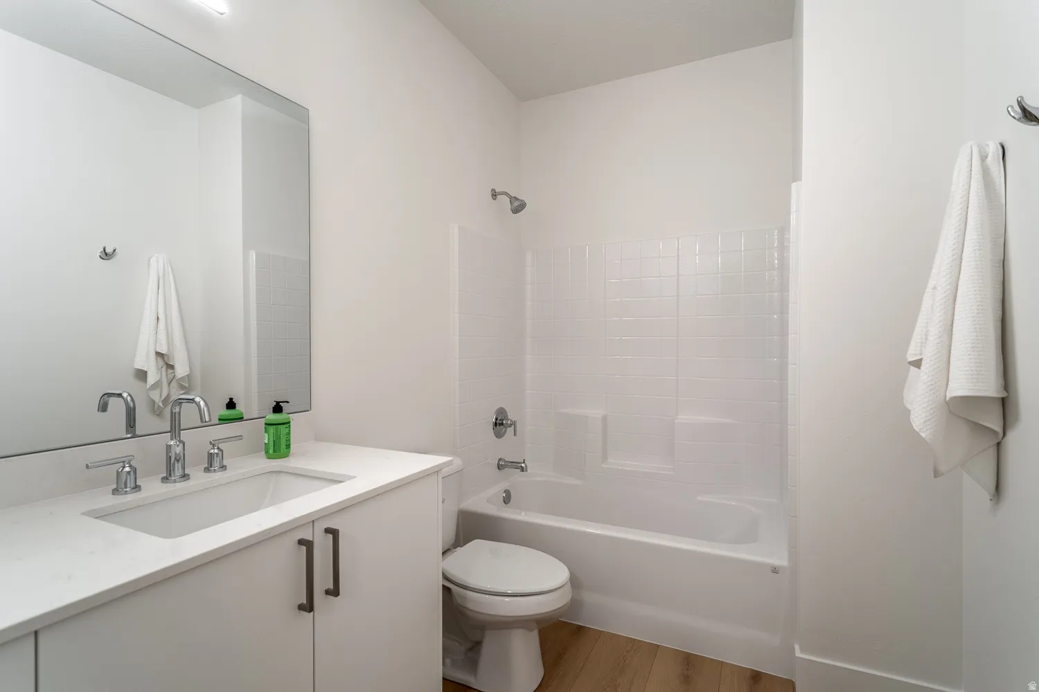Full bathroom featuring vanity, light wood finished floors, and shower / tub combination