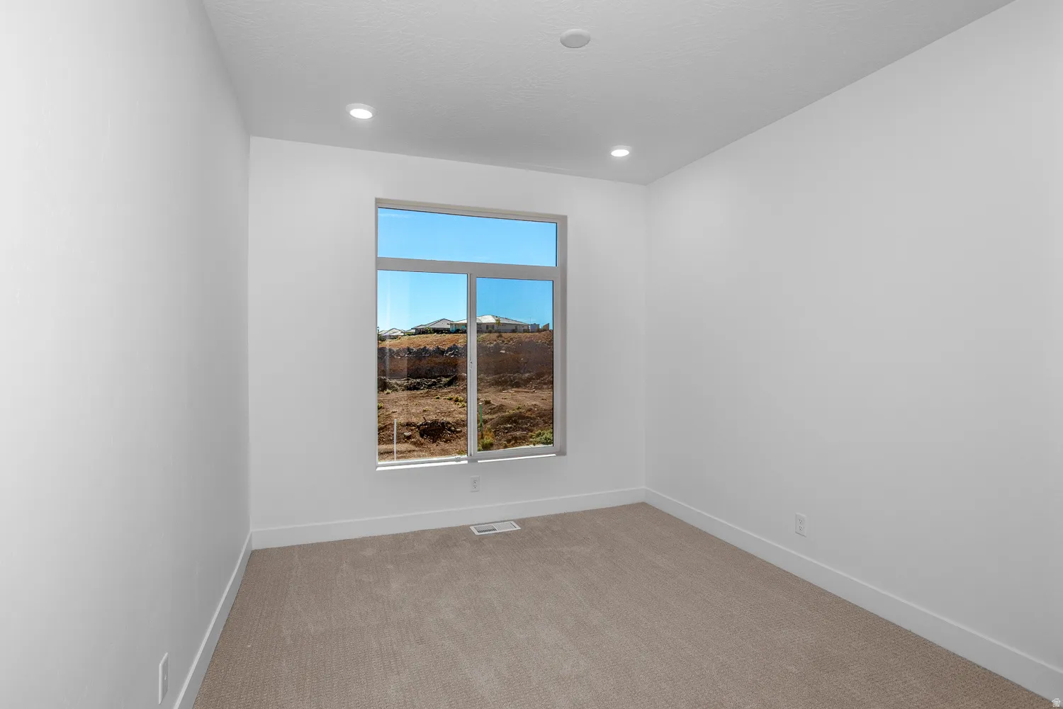 Unfurnished room featuring light carpet and recessed lighting