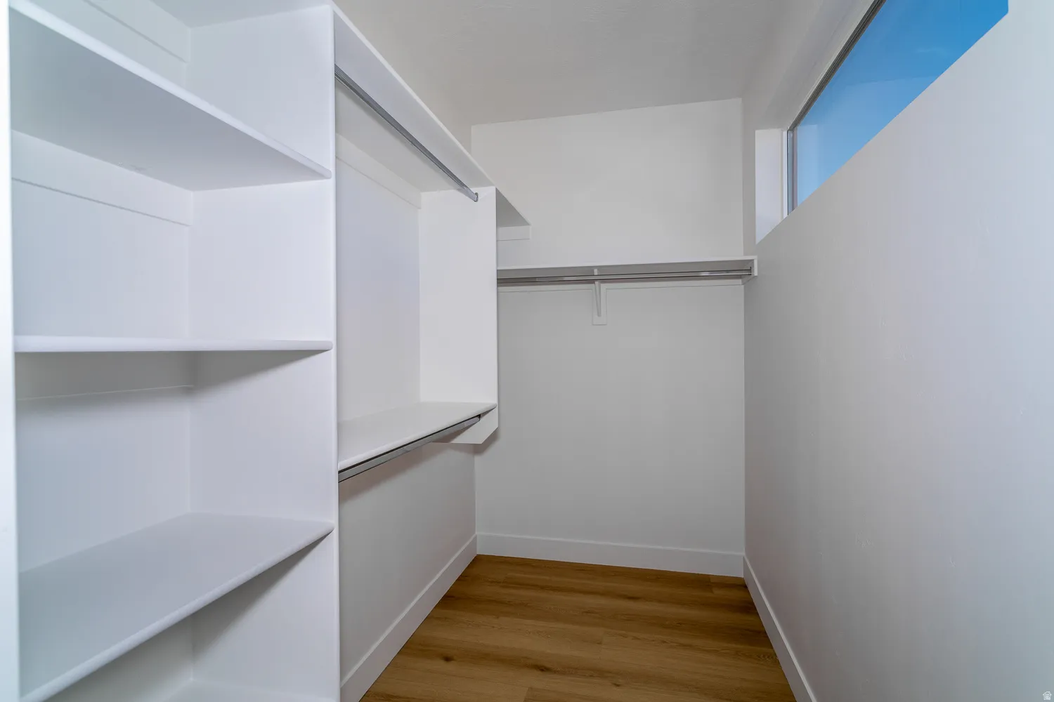 Walk in closet featuring light wood-style floors