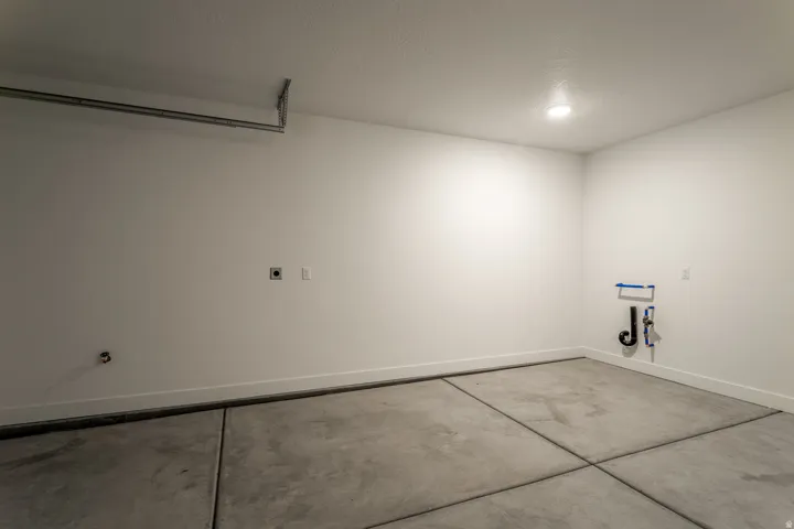 Garage featuring baseboards