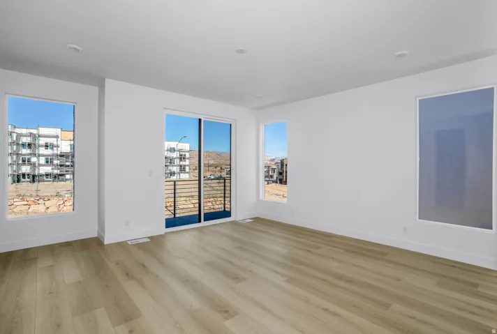 Empty room with light wood finished floors and baseboards