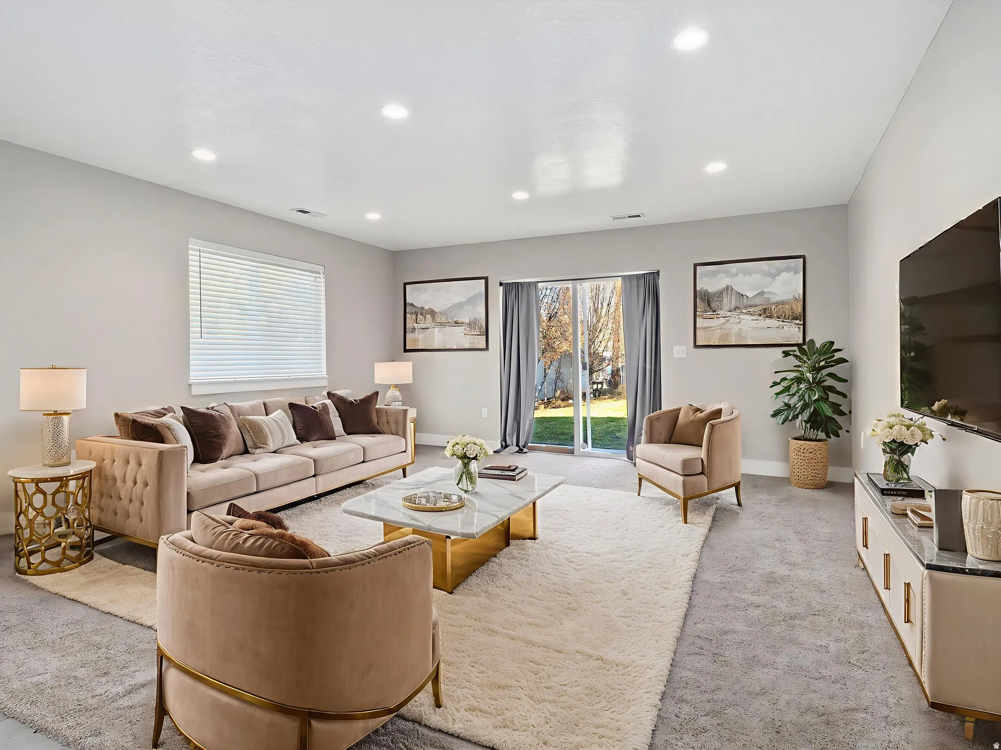 Living room with light colored carpet and recessed lighting