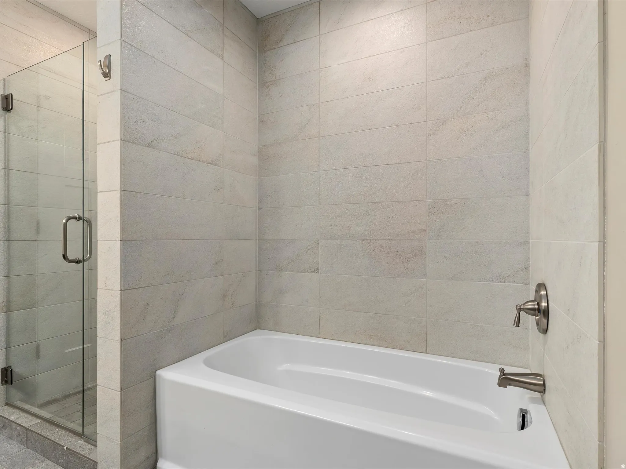 Full bath featuring a stall shower and a garden tub
