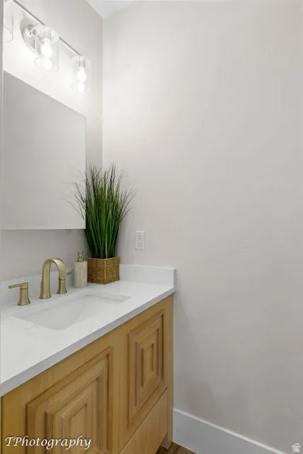 Bathroom with vanity and baseboards