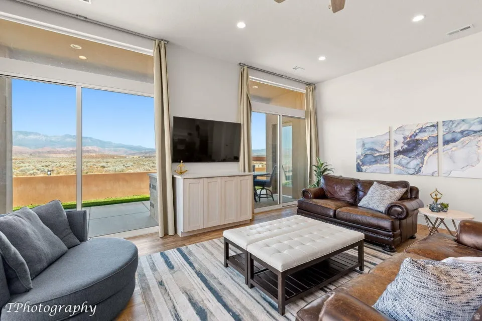 Living room featuring light wood-style floors, ceiling fan, and recessed lighting